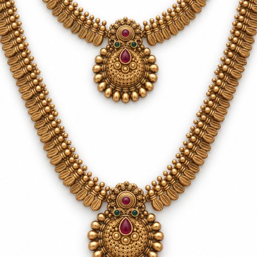 Close-up of antique gold leaf chain necklace teardrop pendant and matching earrings