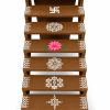 Brown seven-step Golu stand with white kolam and pink lotus designs on a white background