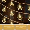 Copper Serial String Lights – 14 LED Diya, 10 Feet Warm White Warm white LED diya string lights displayed around a home mandir for Diwali