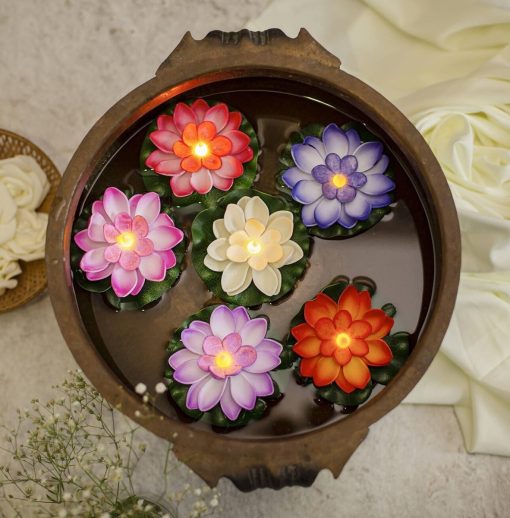 Assorted multicolour floating lotus LED water sensor diyas displayed in decorative bowl