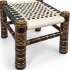 White and black woven wooden Khatli stool professional side view