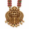 Antique Gold Lakshmi Temple Necklace Set with Jhumka Earrings Close-up of antique gold Lakshmi pendant with peacock details and pink and green stones