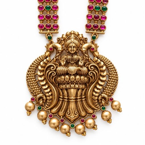 Close-up of antique gold Lakshmi pendant with peacock details and pink and green stones