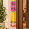 Pink and Yellow Artificial Flower Garland with Gold Bells – 7 ft Pink and yellow 7 ft garland with gold bells displayed beside a doorway