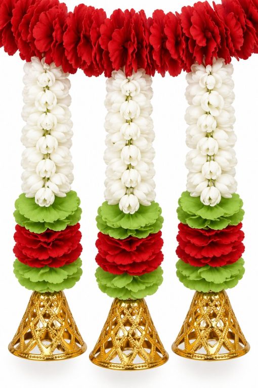 Close-up of red and white artificial flowers with green collars and ornate gold bells