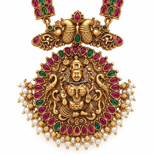Close-up of antique gold Tirupati Balaji pendant with peacock motifs, pink and green stones, and pearl details