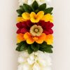 Close-up of white toran with red yellow orange flowers and green leaves