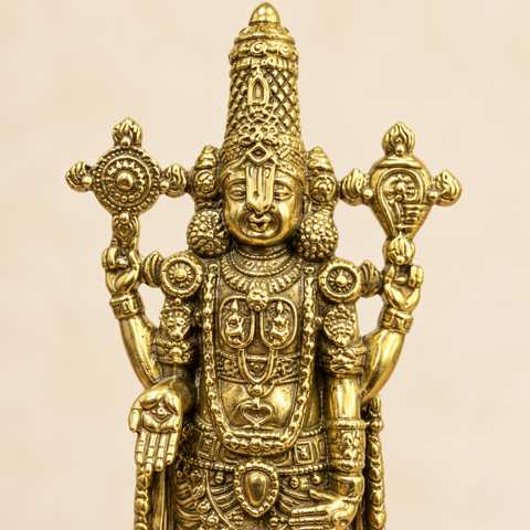 Close-up detail of the gold-tone Lord Venkateswara statue